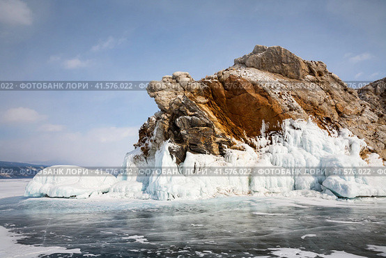 Baikal Lake on frosty day in February. View from ice to icy rocky islet in Small Sea. Scenic winter landscape. Natural background. Ice travel and outdoor recreation. Стоковое фото, фотограф Виктория Катьянова / Фотобанк Лори