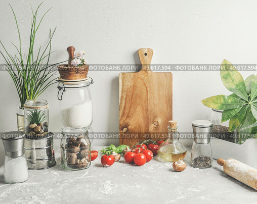 Baking background of savory with kitchen utensils, rolling pin , flour, ingredients and fresh vegetables at white wall . Sustainable lifestyle. Front view. Стоковое фото, агентство Ingram Publishing / Фотобанк Лори