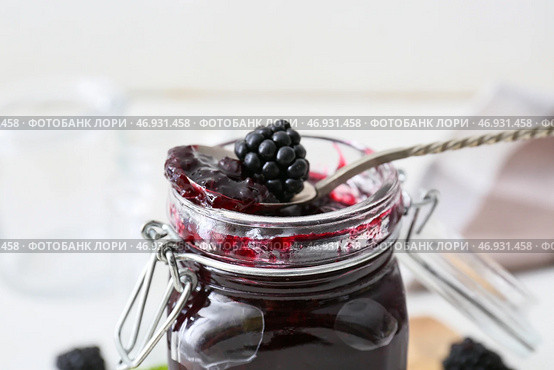 Банка и ложка с вкусным ежевичным джемом на светлом фоне, крупным планом. Стоковое фото, фотограф Pixel_shot / Фотобанк Лори