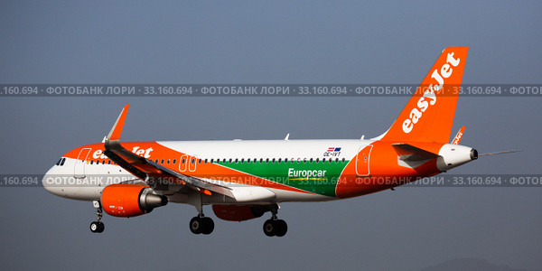 Barcelona, El Prat - January 24, 2020: Airline EasyJet plane comes in for a landing in an aeroport El Prat city of Barcelona. Board number OE-IVT. Редакционное фото, фотограф Яков Филимонов / Фотобанк Лори