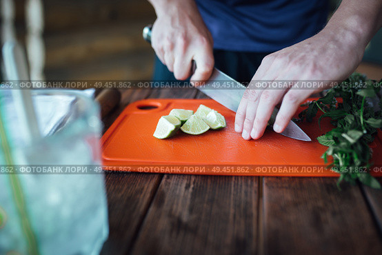 Barman prepares fruit alcohol cocktail based on lime, mint, orange, soda and alcohol. Стоковое фото, агентство Ingram Publishing / Фотобанк Лори