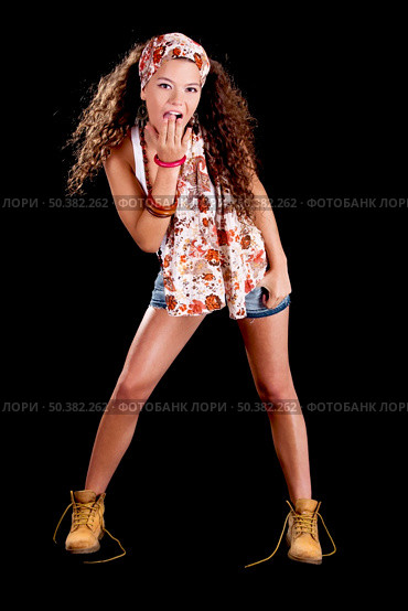 Beautiful and fashion young woman isolated on a black background. Стоковое фото, агентство Ingram Publishing / Фотобанк Лори