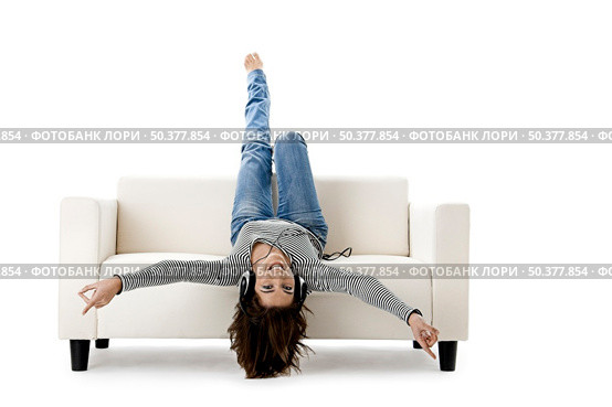 Beautiful happy woman listen music with headphones. Стоковое фото, агентство Ingram Publishing / Фотобанк Лори