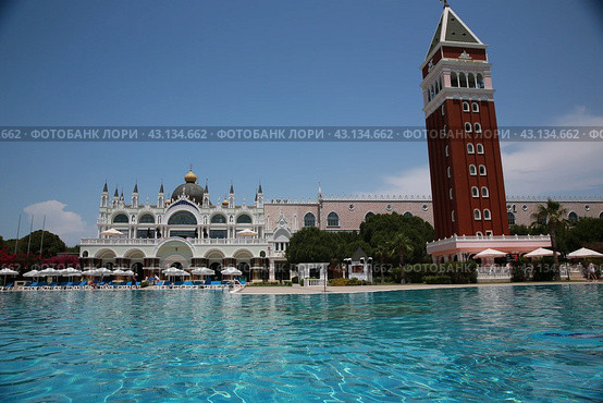 Beautiful hotel with tall tower from red bricks designed by Italian Venis style early morning (2018 год). Редакционное фото, фотограф Константин Сергеевич Синявин / Фотобанк Лори