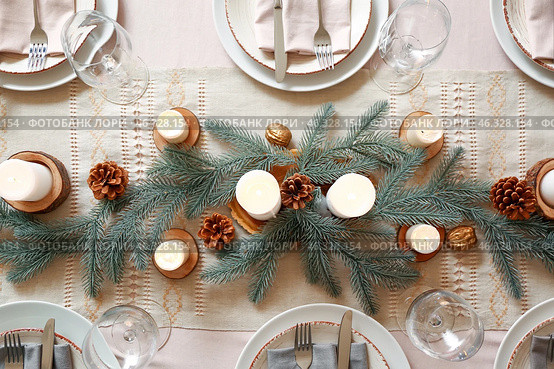 Beautiful table setting with Christmas decorations in living room. Стоковое фото, фотограф Pixel_shot / Фотобанк Лори