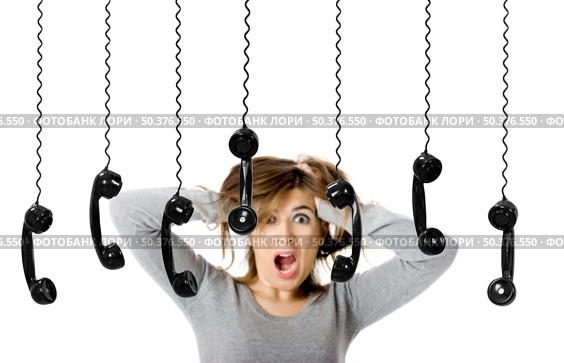 Beautiful woman in shock looking to a lot of telephones. Стоковое фото, агентство Ingram Publishing / Фотобанк Лори