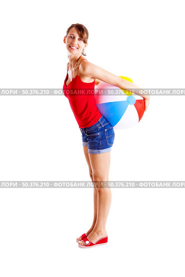 Beautiful young woman posing with a beach ball. Стоковое фото, агентство Ingram Publishing / Фотобанк Лори