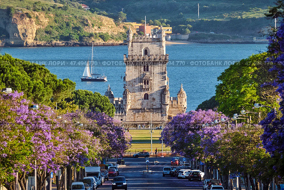 Belem Tower in Lisbon Framed by Blooming Jacaranda Trees and Sailboats on the Tagus River, Portugal (2024 год). Стоковое фото, фотограф Дмитрий Рухленко / Фотобанк Лори