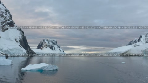 Big Iceberg in Antarctica Winter Scenery, Amazing Shape Ice Formation of Massive Large Enormous Blue Icebergs in Antarctic Peninsula Landscape Seascape with Ocean Sea Water. Стоковое видео, видеограф Vladimir / Фотобанк Лори