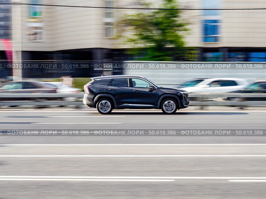 Black Geely Boyue SUV car on the city road. Fast moving vehicle on Moscow streets. Compliance with speed limits on the road. Редакционное фото, фотограф Константин Григорьев / Фотобанк Лори