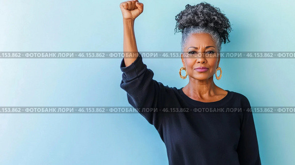 Black mature woman with raised fist of empowerment, strength and women solidarity, International Womens Day, Black History Month concept. Стоковое AI-изображение, AI-художник Анастасия Золотницкая / Фотобанк Лори