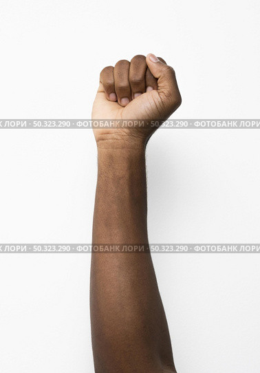 black person holding fist up. Стоковое фото, агентство Ingram Publishing / Фотобанк Лори
