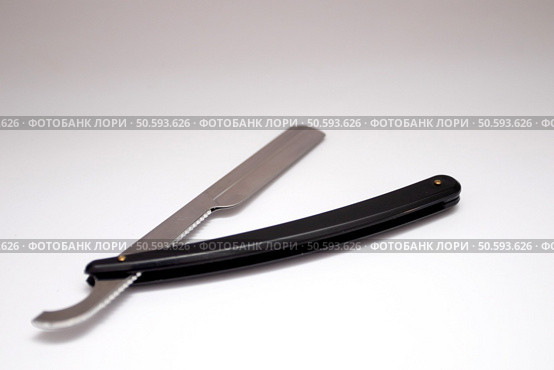 Black straight dangerous razor on a white background. Black straight dangerous razor on a white background. Стоковое фото, агентство Ingram Publishing / Фотобанк Лори