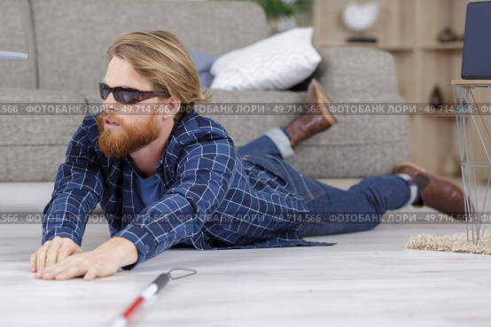 blind man fallen on the floor in his home. Стоковое фото, агентство Ingram Publishing / Фотобанк Лори
