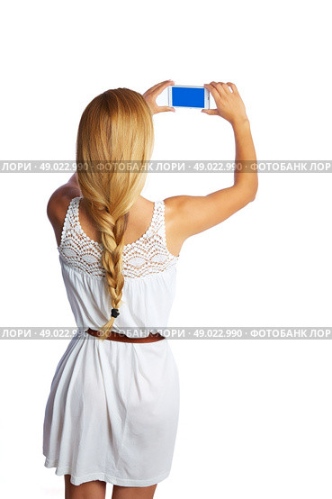 Blond tourist girl taking photos with smartphone on white background and braid. Стоковое фото, агентство Ingram Publishing / Фотобанк Лори
