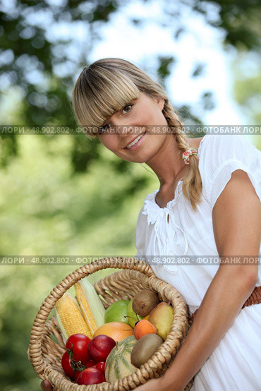 blonde woman showing a fruits basket. Стоковое фото, агентство Ingram Publishing / Фотобанк Лори