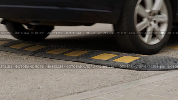 Blue Car Passes Speed Bumper on Street Road. Pedestrian Safety and Speed Control. Стоковое видео, видеограф Денис Кебедов / Фотобанк Лори