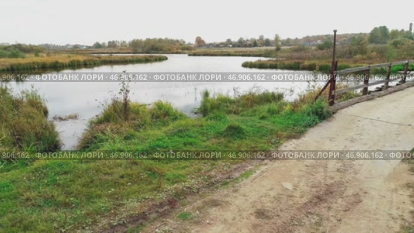 Body of water with a lot of vegetation surrounding it. Autumn flight over the source of the forest river. Стоковое видео, видеограф Надежда Кап / Фотобанк Лори