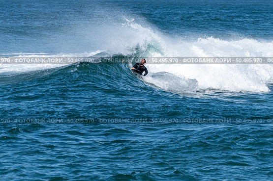 Bodyboarder surfing ocean wave on a sunny winter day. Стоковое фото, агентство Ingram Publishing / Фотобанк Лори