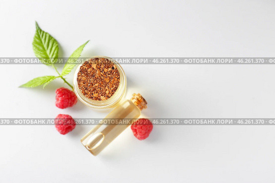 Bottles of raspberry essential oil on light background. Стоковое фото, фотограф Pixel_shot / Фотобанк Лори