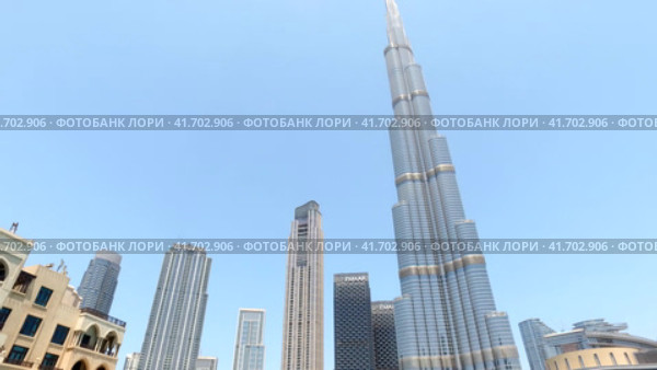 Bottom view of panorama Burj Khalifa at blue sky in tourist district of Dubai city, UAE (2023 год). Стоковое видео, видеограф Aleksandr Golubev / Фотобанк Лори
