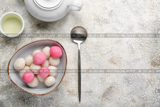 Bowl of tangyuan, cup and teapot on grunge background. Dongzhi Festival. Стоковое фото, фотограф Pixel_shot / Фотобанк Лори