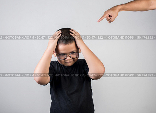 Boy feels sad after the parents scold him. Стоковое фото, агентство Ingram Publishing / Фотобанк Лори