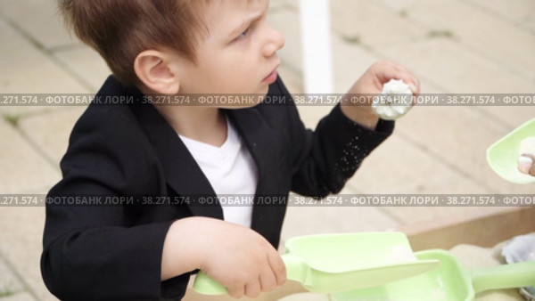 Boy playing in the sandbox. Стоковое видео, видеограф Потийко Сергей / Фотобанк Лори