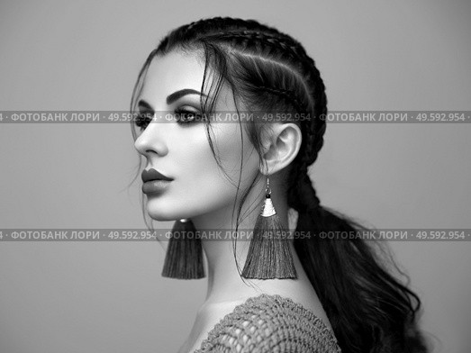 Brunette girl with perfect makeup. Beautiful model woman with curly hairstyle. Care and beauty hair products. Lady with braided hair. Model with jewelry. Black and white photo. Стоковое фото, агентство Ingram Publishing / Фотобанк Лори