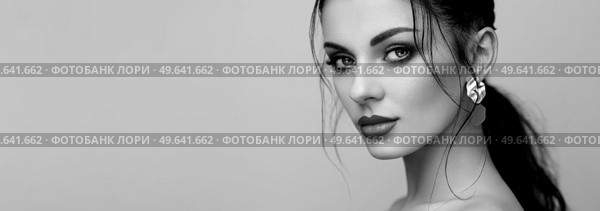 Brunette girl with perfect makeup. Beautiful model woman with curly hairstyle. Care and beauty hair products. Lady with braided hair. Model with jewelry. Black and White photo. Стоковое фото, агентство Ingram Publishing / Фотобанк Лори