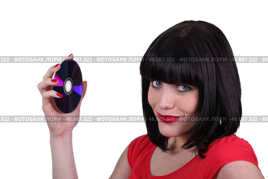 brunette woman showing a compact disc. Стоковое фото, агентство Ingram Publishing / Фотобанк Лори