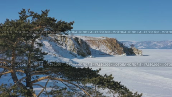 Burkhan rock cape in frozen lake Baikal. Стоковое видео, видеограф Михаил Коханчиков / Фотобанк Лори