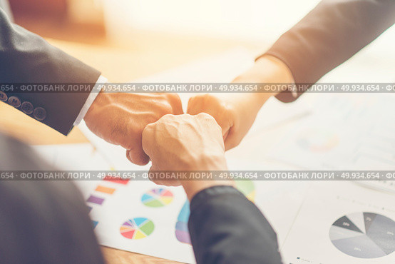 business people join hand while meeting in office. Стоковое фото, агентство Ingram Publishing / Фотобанк Лори