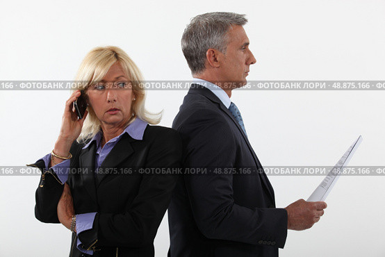 Business professionals standing back to back. Стоковое фото, агентство Ingram Publishing / Фотобанк Лори
