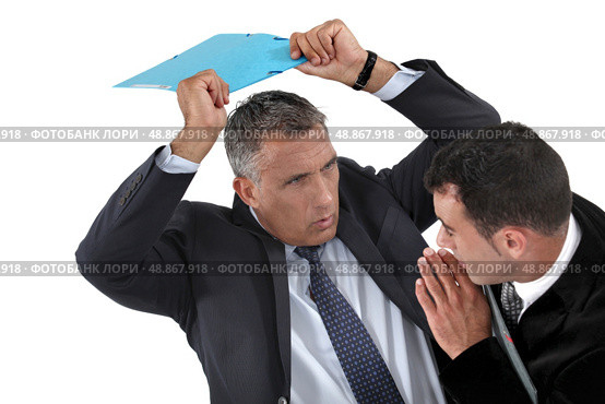 Businessman hitting a colleague. Стоковое фото, агентство Ingram Publishing / Фотобанк Лори