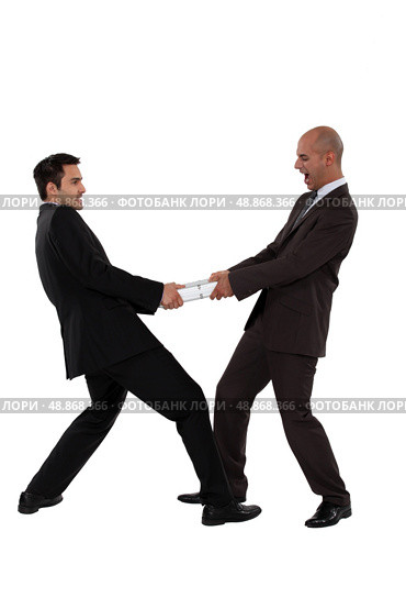 Businessman pulling in different directions. Стоковое фото, агентство Ingram Publishing / Фотобанк Лори
