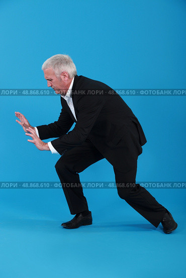 Businessman pushing against empty copyspace. Стоковое фото, агентство Ingram Publishing / Фотобанк Лори