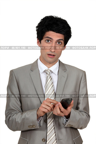 Businessman sending a text message. Стоковое фото, агентство Ingram Publishing / Фотобанк Лори