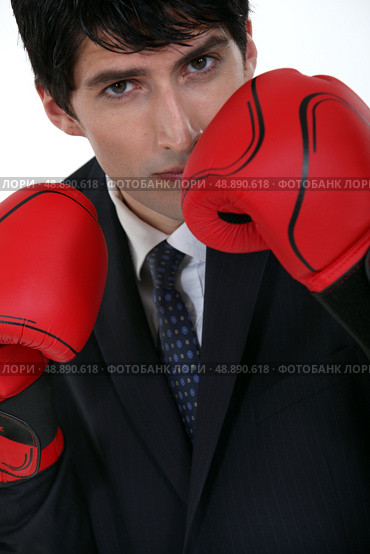 Businessman wearing boxing gloves. Стоковое фото, агентство Ingram Publishing / Фотобанк Лори