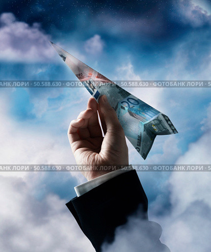 Businessman’s hand holding airplane made of Euros. 24316763. Стоковое фото, агентство Ingram Publishing / Фотобанк Лори
