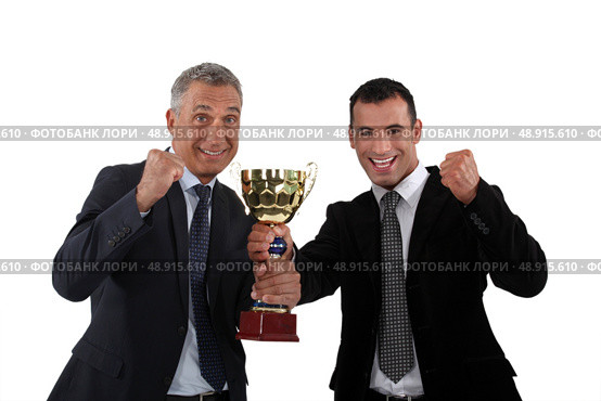 Businessmen holding a golden cup. Стоковое фото, агентство Ingram Publishing / Фотобанк Лори