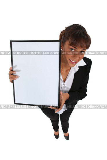 Businesswoman holding up a whiteboard. Стоковое фото, агентство Ingram Publishing / Фотобанк Лори