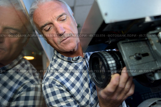 cameraman controls focus on television videocamera. Стоковое фото, агентство Ingram Publishing / Фотобанк Лори