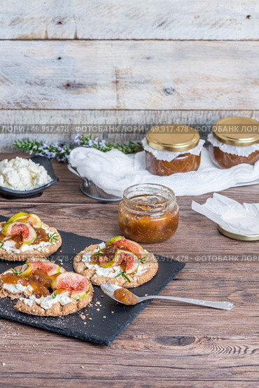 Canape or crostini with multigrain  crispread with cream cheese and fig jam on a slate board. Delicious appetizer ideal as an aperitif. Стоковое фото, агентство Ingram Publishing / Фотобанк Лори