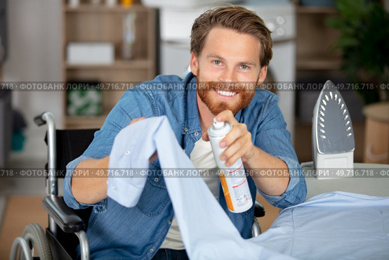 capable disabled man ironing a shirt. Стоковое фото, агентство Ingram Publishing / Фотобанк Лори