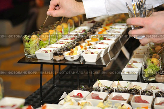 Catering stuff arranging finger food. Стоковое фото, агентство Ingram Publishing / Фотобанк Лори