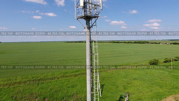 Cellular tower. Equipment for relaying cellular and mobile signal. Fly around up and down. Стоковое фото, фотограф Леонид Еремейчук / Фотобанк Лори