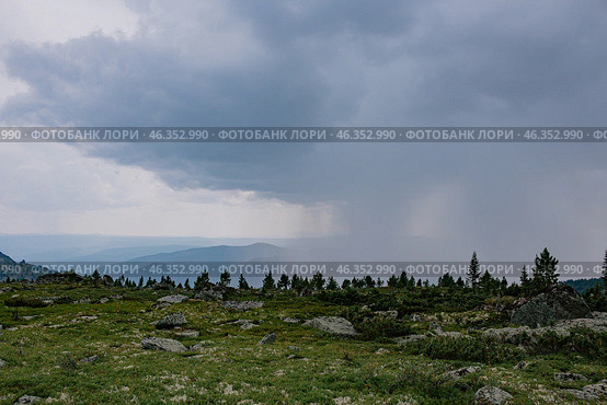 Change of weather in the mountains, thundercloud brought heavy rain like a wall. Natural landscape on hike at summer day. Стоковое фото, фотограф Екатерина Якименко / Фотобанк Лори