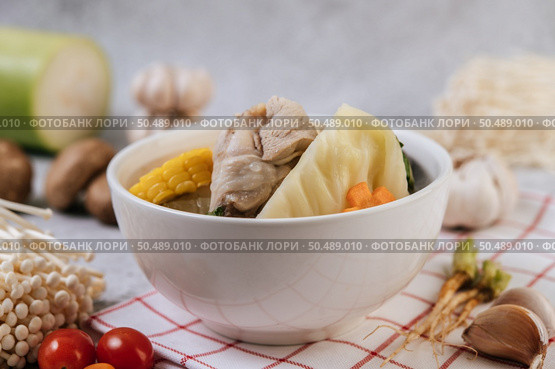 Chicken soup with corn, shiitake mushroom, enoki mushroom, and carrot. Стоковое фото, агентство Ingram Publishing / Фотобанк Лори