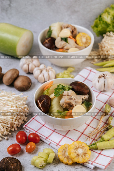 Chicken soup with corn, shiitake mushroom, enoki mushroom, and carrot. Стоковое фото, агентство Ingram Publishing / Фотобанк Лори